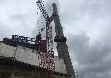 A crane is in front of the building.